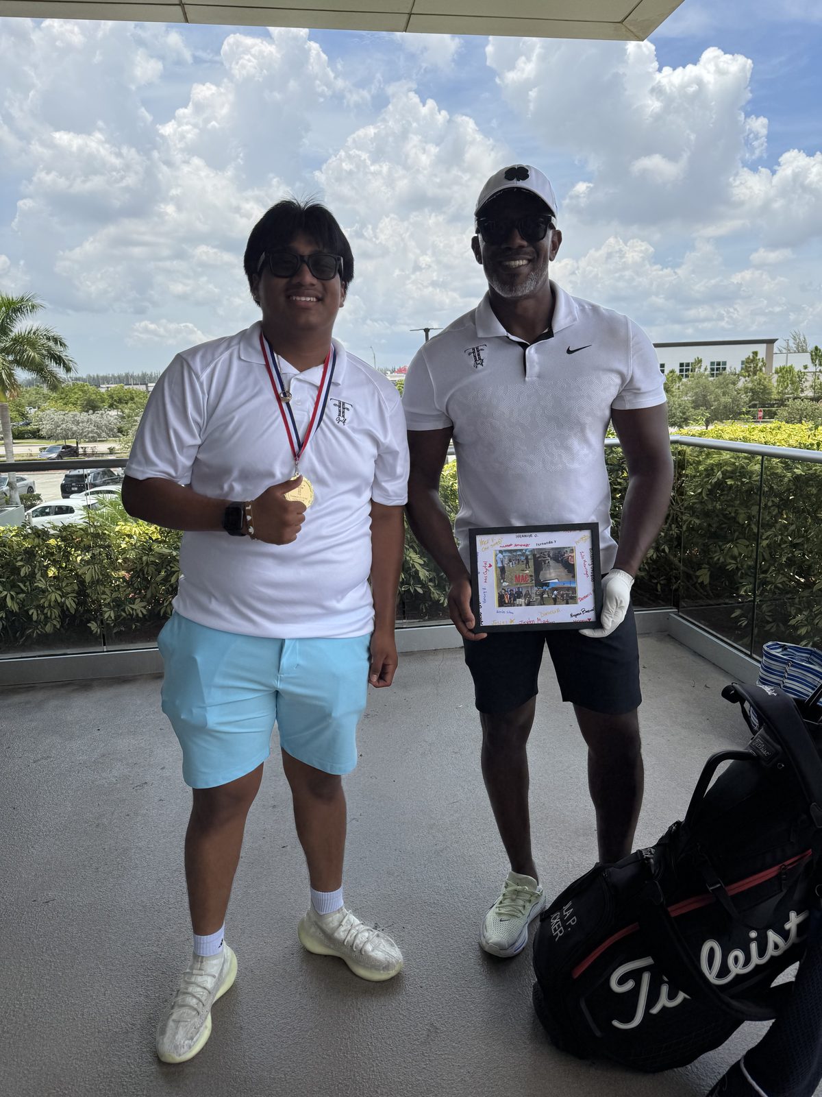 FFGF participant with a medal alongside a coach