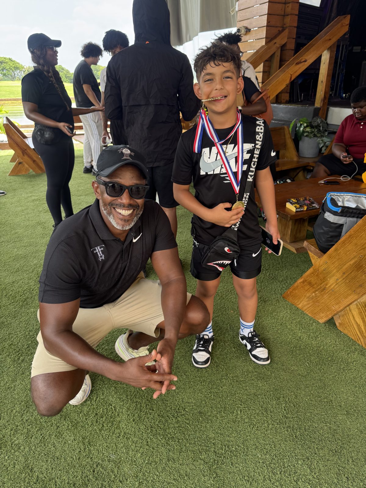 FFGF coach with a medaled youth participant