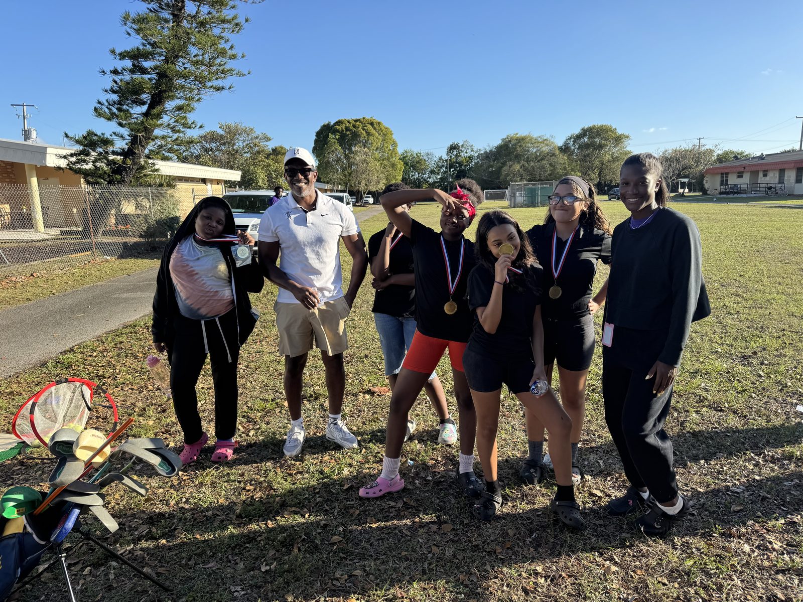 FFGF youth golf program participants outdoors with medals and clubs